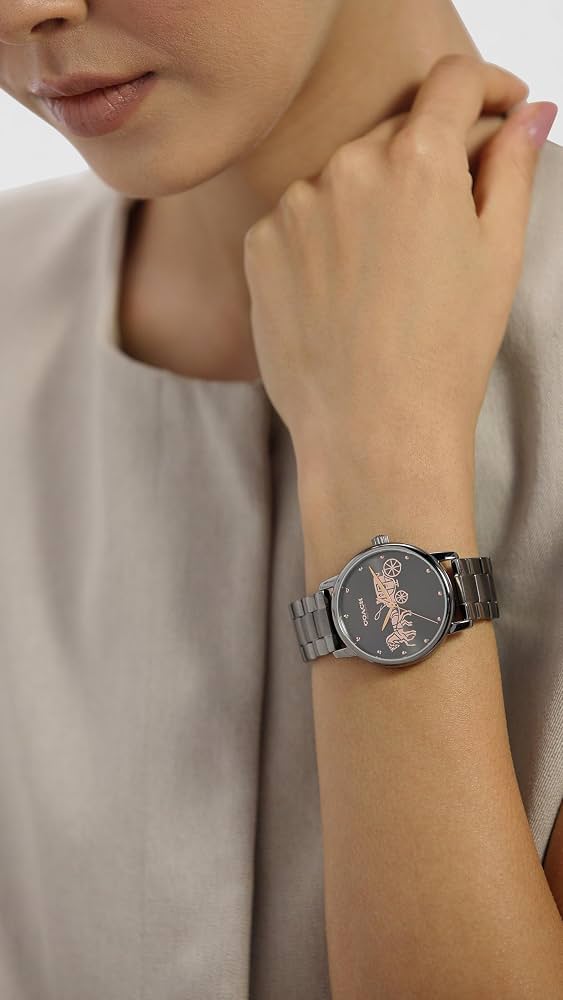 Coach Grand watch on wrist showing dark grey dial and gunmetal-tone bracelet with rose gold detailing