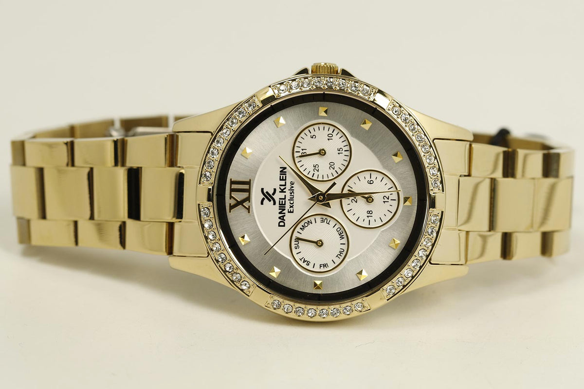 Side angle view of gold multifunction watch with link bracelet and dial detail