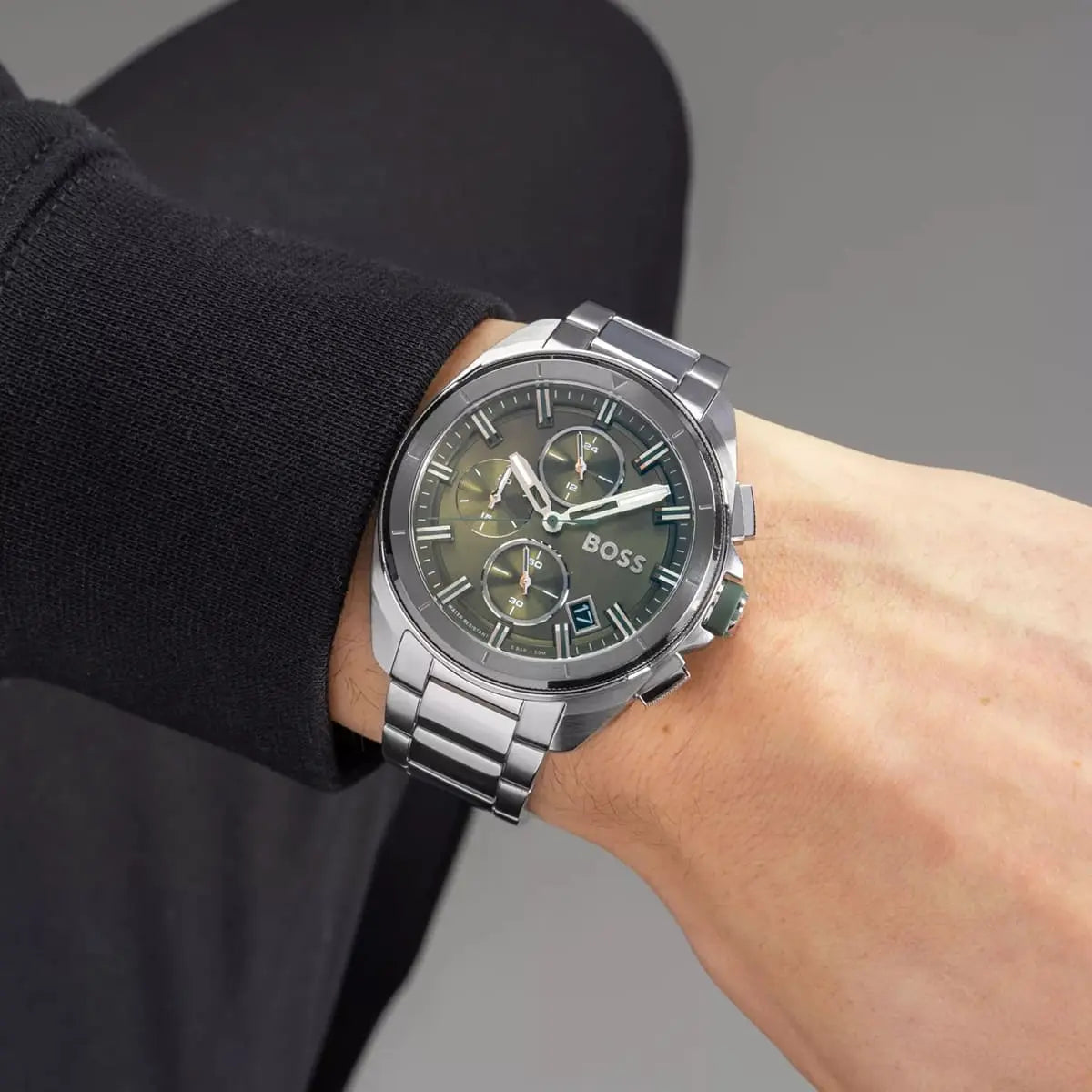 Hugo Boss chronograph watch on wrist with dark sleeve styling