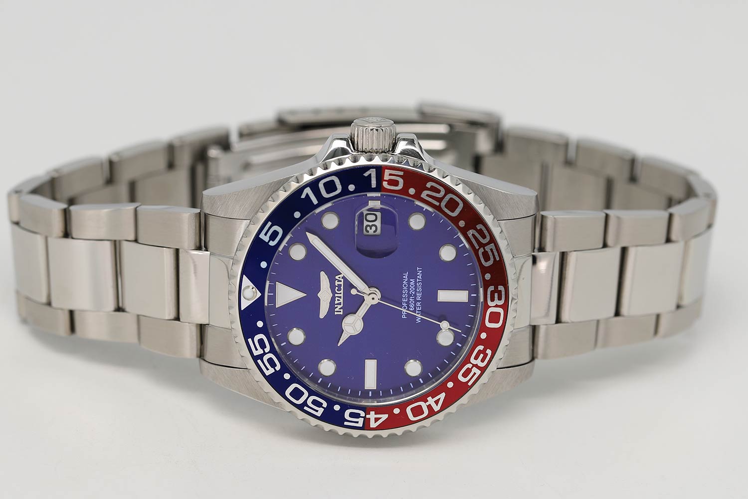 Invicta Pro Diver watch on wrist showing full stainless steel bracelet and dial