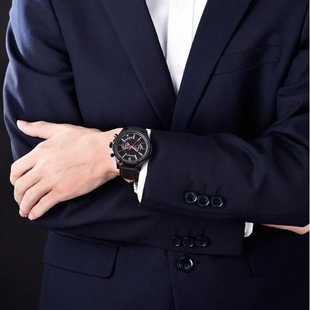 Maserati Circuito black watch on wrist with navy blue suit jacket