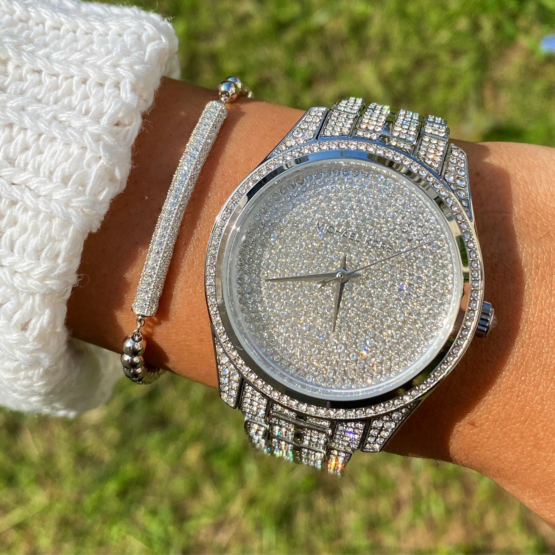 Michael Kors Lauryn Pave silver-tone watch worn on wrist with bracelet
