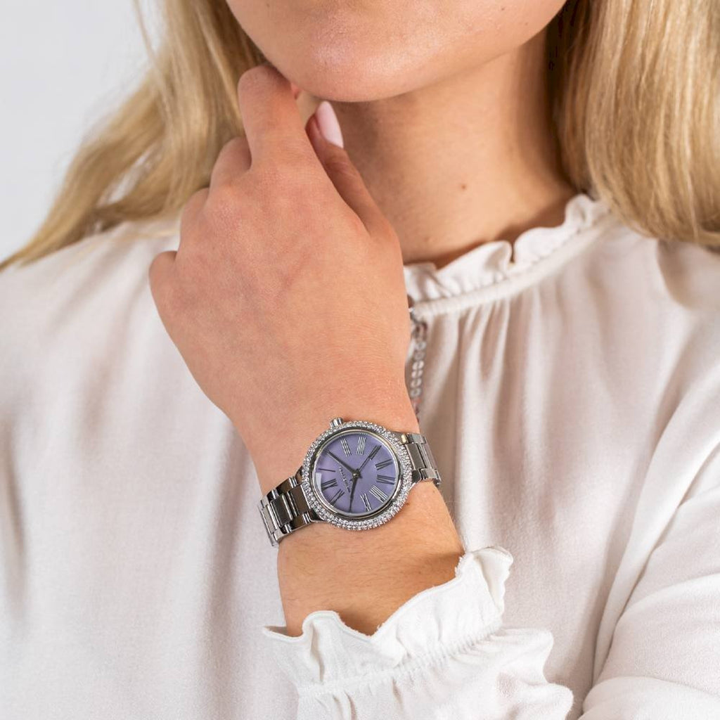 Michael Kors Mini Taryn watch worn on wrist with purple dial and silver-tone bracelet