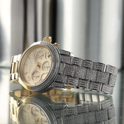 Angled view of MK7329 Runway chronograph with cream dial and crystal-set bezel details