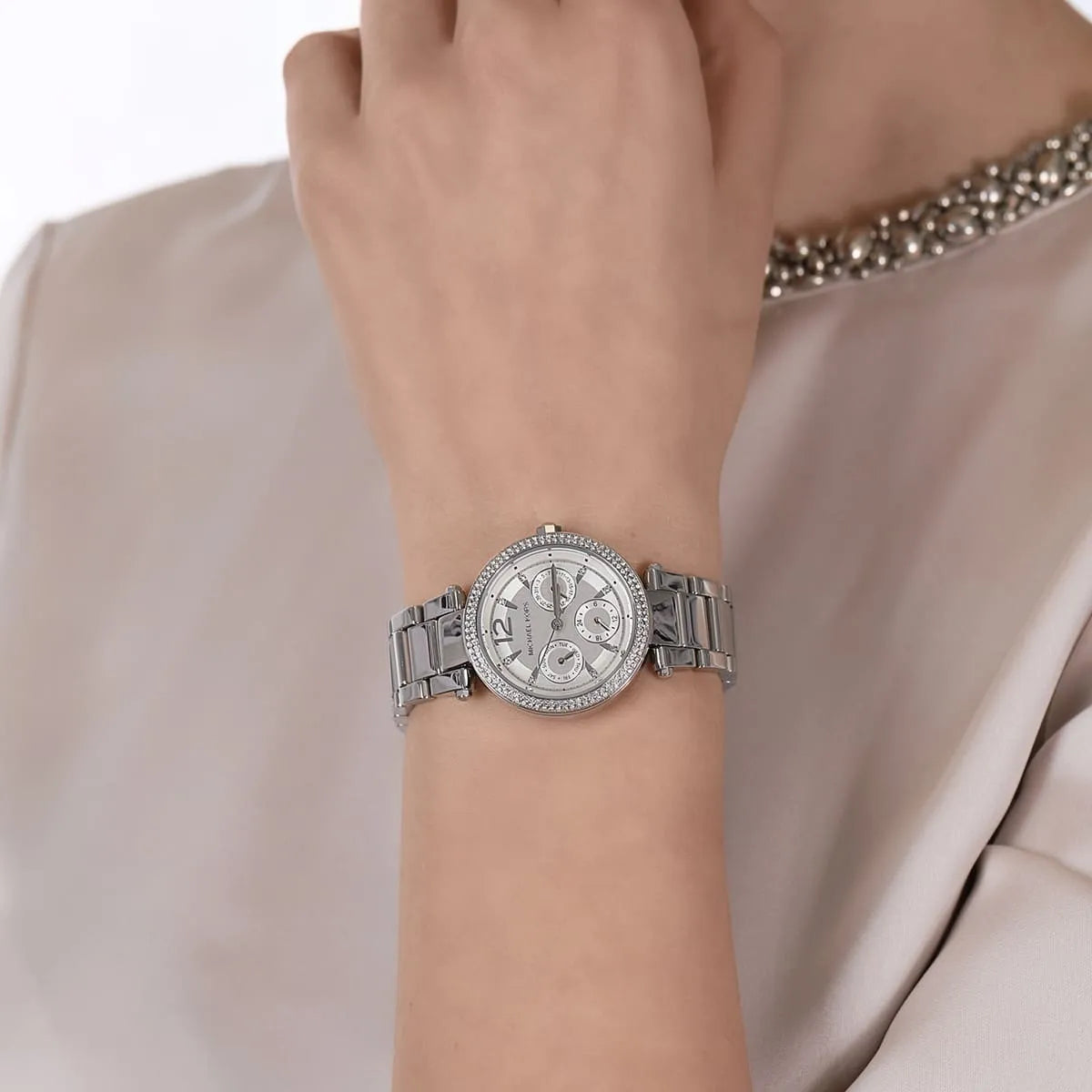 Michael Kors Parker Mini multifunction watch worn on wrist with stainless steel bracelet