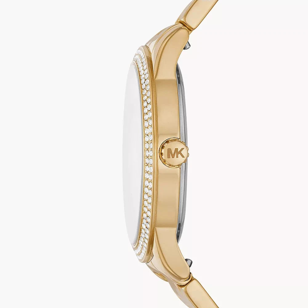 Side profile of Michael Kors Tibby watch showing gold case, crystal-set bezel, and link bracelet