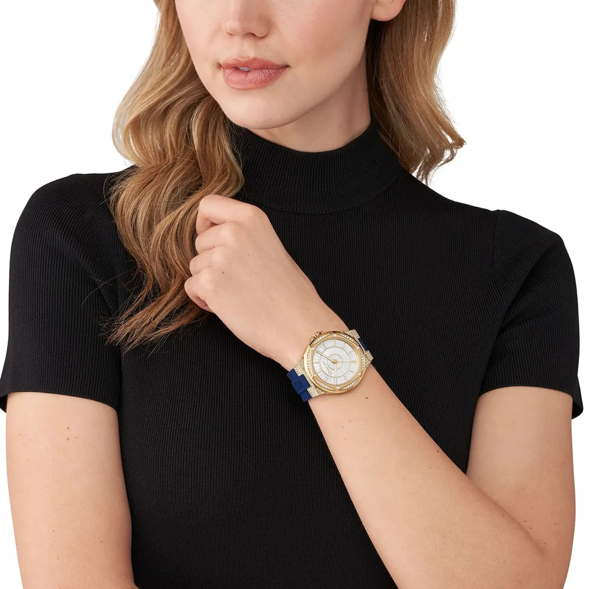Michael Kors Oversized Lennox Pavé watch worn on wrist with white dial and blue silicone strap