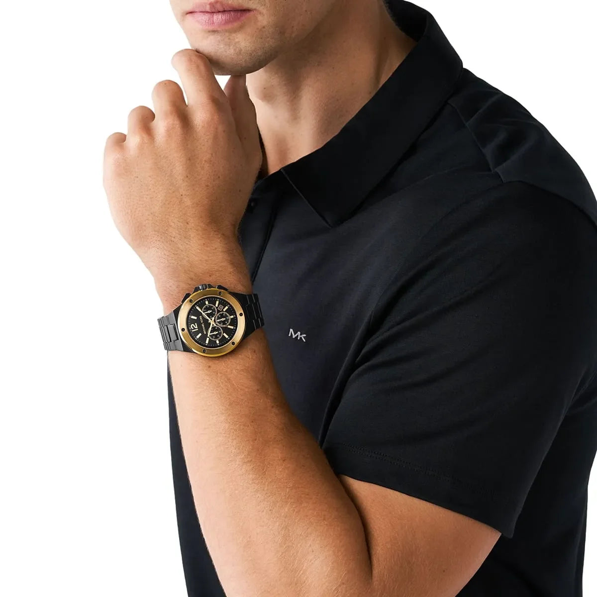 Michael Kors Lennox watch worn on wrist showing black dial with gold accents and chronograph subdials