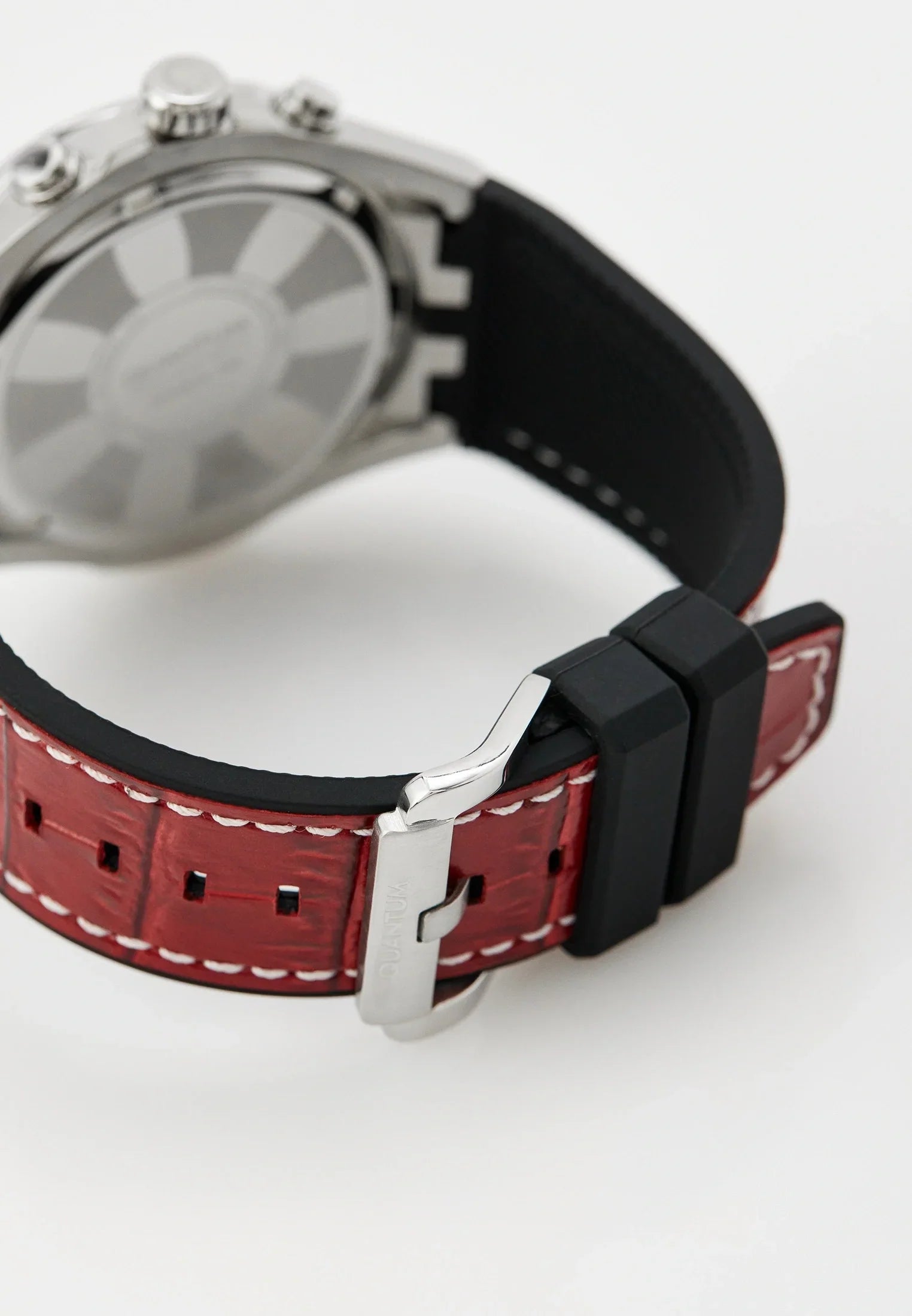 Quantum watch worn on wrist showing gunmetal dial and red silicon strap