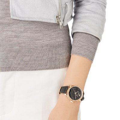 Swarovski Crystalline Hours watch worn on wrist with black leather strap