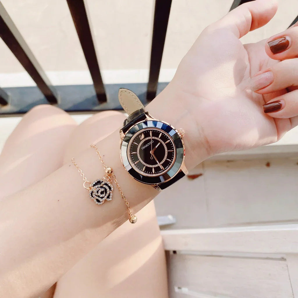 Swarovski Octea Lux watch worn on wrist showing black dial and rose-gold case