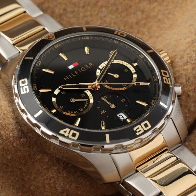 Close-up of Tommy Hilfiger 1792095 black dial with chronograph subdials and gold hands