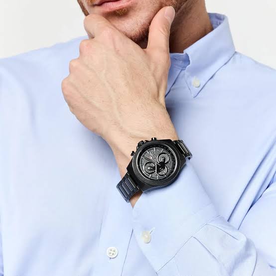 Tommy Hilfiger Damon chronograph watch worn on wrist with light blue dress shirt