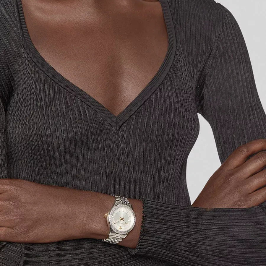 Versace Hellenyium watch worn on wrist, showing white dial and silver steel bracelet